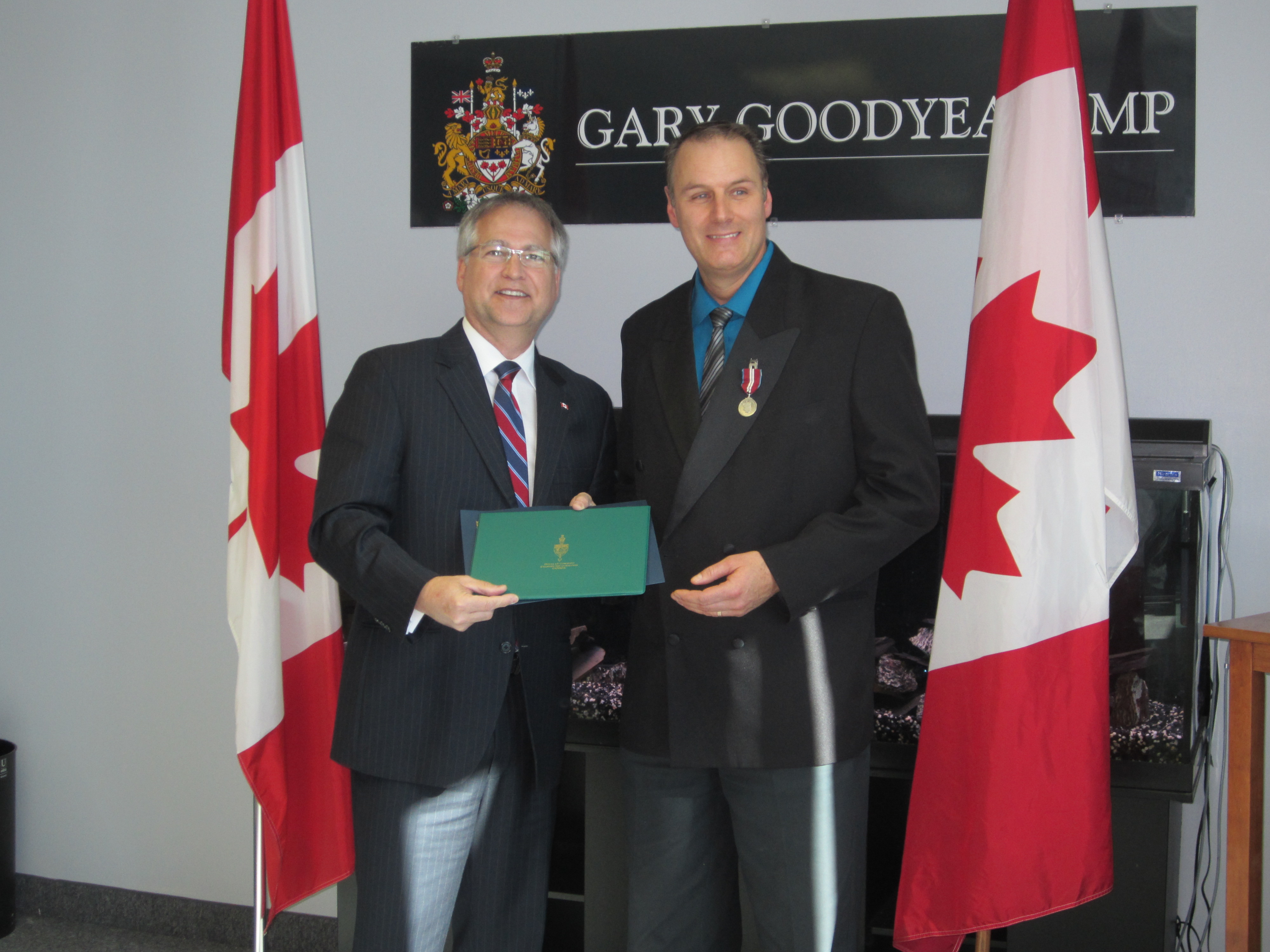 Dr. Paul Blaser being awarded the Jubilee medal from Gary Goodyear MP
