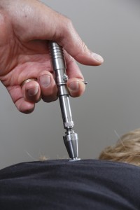 Dr. Paul Blaser applying an Activator for Chiropractic adjustment